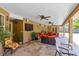 Spacious covered patio with tile flooring, multiple ceiling fans, and comfortable seating areas for outdoor entertaining at 4674 Hall Rd, Orlando, FL 32817