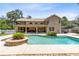 Resort-style backyard oasis with pool, covered patio, and a second-story balcony overlooking the backyard at 4674 Hall Rd, Orlando, FL 32817