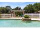 Beautiful in-ground pool with a fountain feature and pergola seating area at 4674 Hall Rd, Orlando, FL 32817