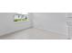 Bright bedroom features tiled floors and a large window overlooking the backyard at 499 Silver Palm Dr, Haines City, FL 33844