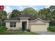 Charming single-story home with a neutral stucco exterior, an attached two-car garage, and verdant landscaping at 499 Silver Palm Dr, Haines City, FL 33844