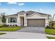 Charming one-story home with a brick driveway, a neutral-toned exterior, and a well-manicured lawn at 499 Silver Palm Dr, Haines City, FL 33844
