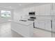 Bright kitchen boasts white cabinets, stainless steel appliances, and ample counter space at 499 Silver Palm Dr, Haines City, FL 33844
