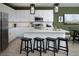 Modern kitchen with white cabinets, stainless steel appliances, a center island, and stylish pendant lighting at 499 Silver Palm Dr, Haines City, FL 33844