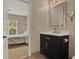 Bathroom featuring a vanity with a modern sink and faucet, a decorative mirror, and tiled flooring at 501 Water St # 501, Celebration, FL 34747
