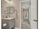 Hallway bathroom featuring a vanity, a mirror, and access to the hallway at 501 Water St # 501, Celebration, FL 34747