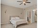 Cozy bedroom featuring carpet flooring, neutral walls, and a view into the en-suite bathroom and closet at 501 Water St # 501, Celebration, FL 34747