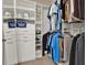 Organized walk-in closet featuring built-in shelving and hanging racks for efficient storage at 501 Water St # 501, Celebration, FL 34747