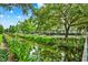 A serene waterway in a community lined with lush landscaping and residences under a partly cloudy sky at 501 Water St # 501, Celebration, FL 34747