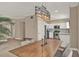Open-concept dining area featuring a wooden table, chairs, and stylish lighting fixture, flowing into a bright kitchen at 501 Water St # 501, Celebration, FL 34747
