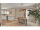 Well-lit dining room with a modern chandelier, seating for four, and view to the kitchen at 501 Water St # 501, Celebration, FL 34747