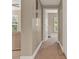 Hallway featuring neutral walls and trim, carpet flooring, and doors leading to other rooms at 501 Water St # 501, Celebration, FL 34747