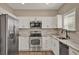Modern kitchen with stainless steel appliances, white cabinets, and granite countertops at 501 Water St # 501, Celebration, FL 34747