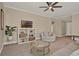 Cozy living room features a ceiling fan, comfortable seating, and a stylish decorative display shelf at 501 Water St # 501, Celebration, FL 34747