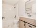 Bathroom with light-colored vanity, matching mirror and updated tub and shower at 5037 Water Wheel Ct, Ocoee, FL 34761