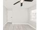Bedroom features a ceiling fan, closet and light grey walls and light grey wood-look flooring at 5037 Water Wheel Ct, Ocoee, FL 34761