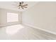 Bright bedroom featuring hardwood floors and ample natural light from a window at 5037 Water Wheel Ct, Ocoee, FL 34761