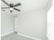 Bedroom features a ceiling fan, closet and light grey walls and light grey wood-look flooring at 5037 Water Wheel Ct, Ocoee, FL 34761