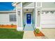 Inviting front entryway featuring a bright blue door and stylish outdoor lighting at 5037 Water Wheel Ct, Ocoee, FL 34761