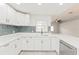 Well-lit kitchen featuring white cabinets and backsplash at 5037 Water Wheel Ct, Ocoee, FL 34761