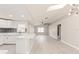 Bright and airy living room with a kitchen, fan and modern lighting fixtures with wood-look flooring at 5037 Water Wheel Ct, Ocoee, FL 34761