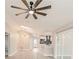 Living room with kitchen features sliding glass doors and light grey wood-look flooring and a fan at 5037 Water Wheel Ct, Ocoee, FL 34761