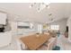 Open-concept living space with kitchen, dining area, living room and recessed lighting. Dining table is virtually staged at 5037 Water Wheel Ct, Ocoee, FL 34761