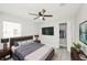 Relaxing main bedroom features a ceiling fan, a modern bed frame and dresser, and closet at 5037 Water Wheel Ct, Ocoee, FL 34761
