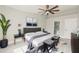 Inviting main bedroom has a king bed, mounted tv, ensuite bath, and natural light at 5037 Water Wheel Ct, Ocoee, FL 34761