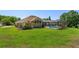 Aerial view of the home with a screened pool and a spacious, well-maintained backyard at 513 N Pine Meadow Dr, Debary, FL 32713