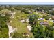 Overhead view of a home near a lush golf course with mature trees, and a community pond at 513 N Pine Meadow Dr, Debary, FL 32713