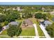 Expansive aerial shot highlighting the property's landscaped yard, mature trees, and neighborhood setting at 513 N Pine Meadow Dr, Debary, FL 32713