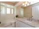 Bathroom featuring white vanity, granite countertop, tub and shower at 513 N Pine Meadow Dr, Debary, FL 32713