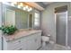 Bathroom with decorative wall texture, white vanity and large mirror at 513 N Pine Meadow Dr, Debary, FL 32713