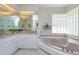 Bathroom featuring double vanity, granite countertop, garden tub and glass block window at 513 N Pine Meadow Dr, Debary, FL 32713