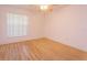 Bedroom with wood floors and a large window with blinds at 513 N Pine Meadow Dr, Debary, FL 32713