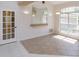 Bright dining room with tile flooring, large window, decorative mirror, and stylish lighting fixtures at 513 N Pine Meadow Dr, Debary, FL 32713