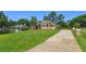 Landscaped front lawn and circular driveway leading to this home at 513 N Pine Meadow Dr, Debary, FL 32713