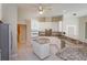 Open kitchen with tile flooring, white cabinets, granite countertops, stainless steel appliances, and ceiling fan at 513 N Pine Meadow Dr, Debary, FL 32713