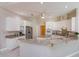 Bright kitchen with white cabinets, granite countertops, stainless steel appliances, and ceiling fan at 513 N Pine Meadow Dr, Debary, FL 32713