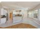 Open kitchen with white cabinets, granite countertops, stainless steel appliances, and tile flooring at 513 N Pine Meadow Dr, Debary, FL 32713