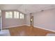 Living room showcasing wood floors, neutral walls, and large windows with shutter-style blinds at 513 N Pine Meadow Dr, Debary, FL 32713