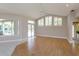Open living room with wood and tile floors, sliding glass doors, and bright windows offering natural light at 513 N Pine Meadow Dr, Debary, FL 32713