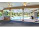 Screened-in lanai with in-ground pool, grill, and covered seating area at 513 N Pine Meadow Dr, Debary, FL 32713