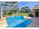 Sparkling pool with screened enclosure surrounded by a manicured lawn and mature trees at 513 N Pine Meadow Dr, Debary, FL 32713