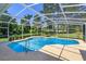 Inviting screened-in pool area featuring clear blue water and ample space for outdoor relaxation at 513 N Pine Meadow Dr, Debary, FL 32713