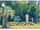 Entrance sign for the Glen Abbey community with mature tropical landscaping at 513 N Pine Meadow Dr, Debary, FL 32713