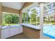 Patio wet bar with a countertop, storage cabinets, and a view of the backyard and pool at 513 N Pine Meadow Dr, Debary, FL 32713