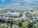Aerial view of houses near a pond, highlighting the community's serene setting and well-maintained landscaping with mature shade trees at 5273 Sunset Canyon Dr, Kissimmee, FL 34758