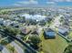 Aerial view of houses near a pond, highlighting the community's serene setting and well-maintained landscaping with mature shade trees at 5273 Sunset Canyon Dr, Kissimmee, FL 34758